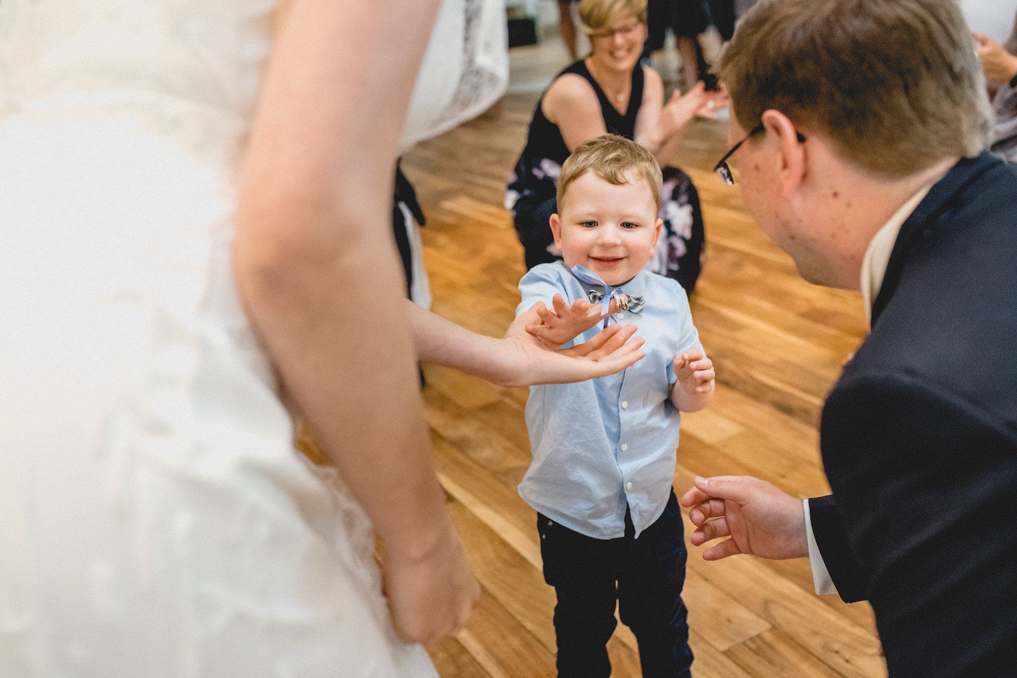 Bride and Groom's son handing them their wedding rings | Documentary Wedding Photography by Maria Assia 