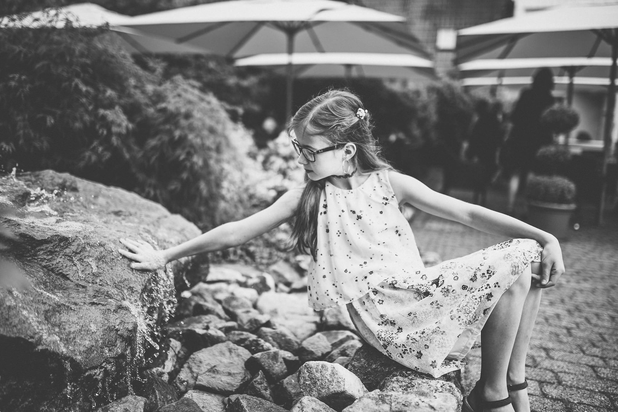 girl playing with a waterfall