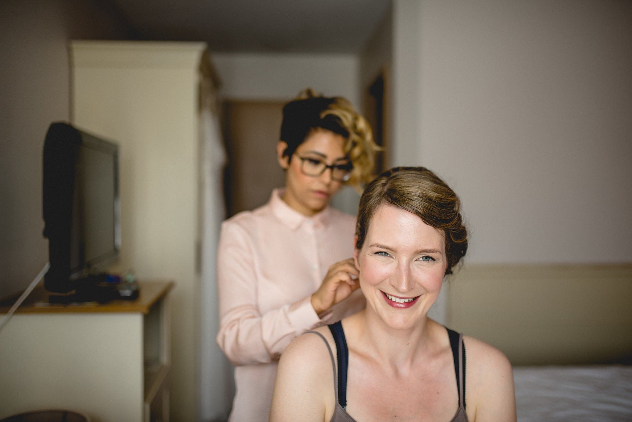 Bride smiling as she gets ready