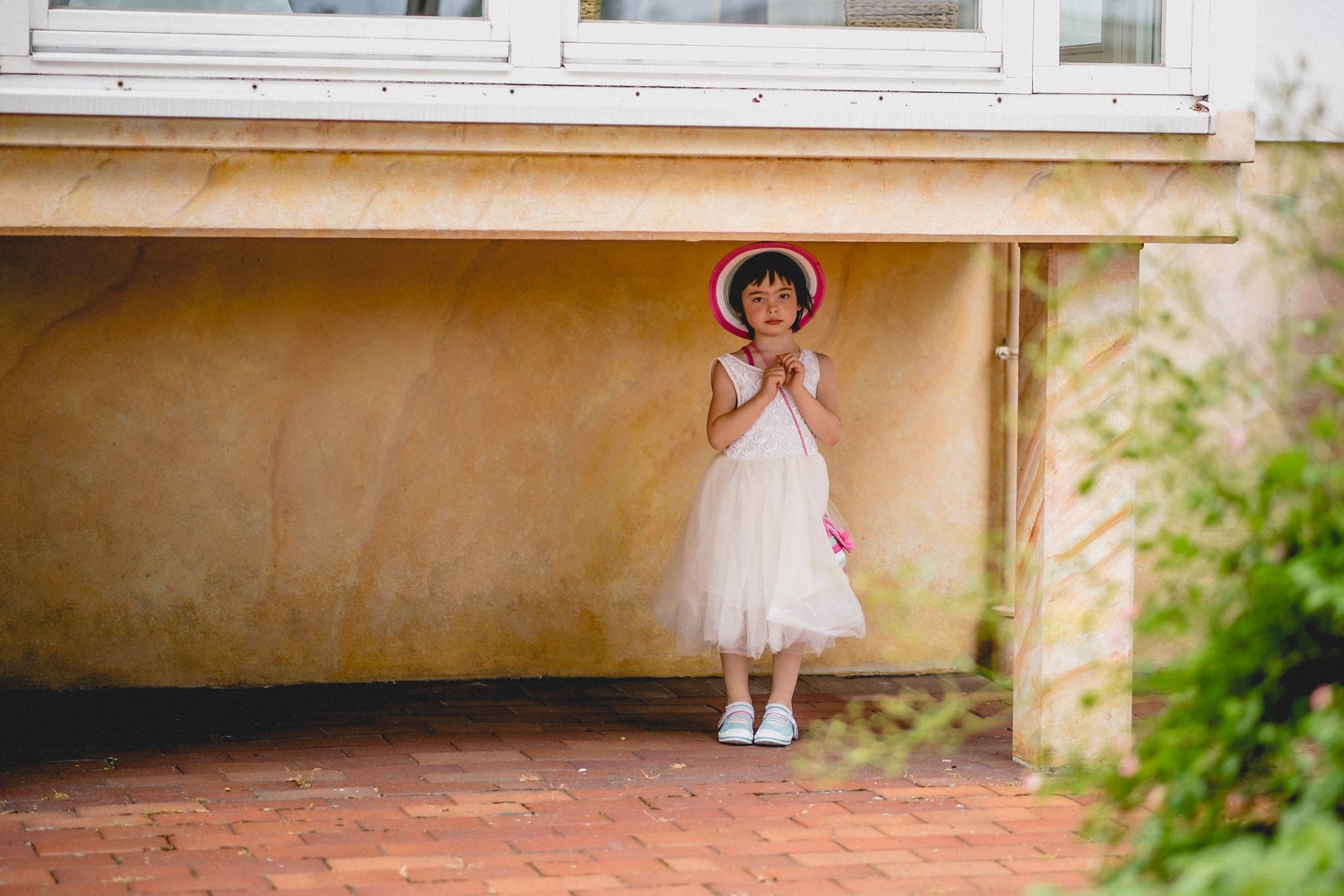 A child standing under a low roof at a wedding