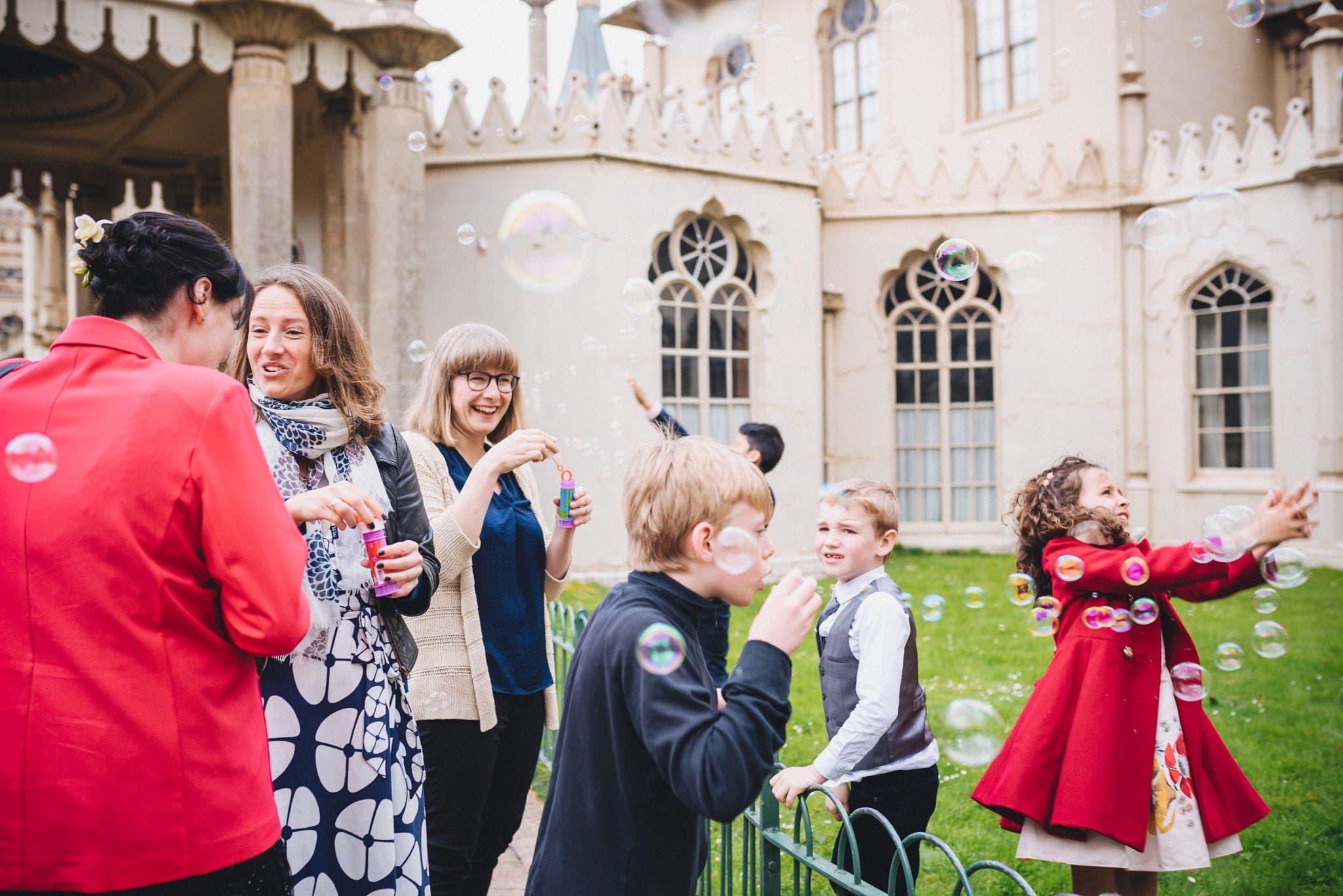 Kids chase bubbles outside Brighton Royal Pavilion Wedding