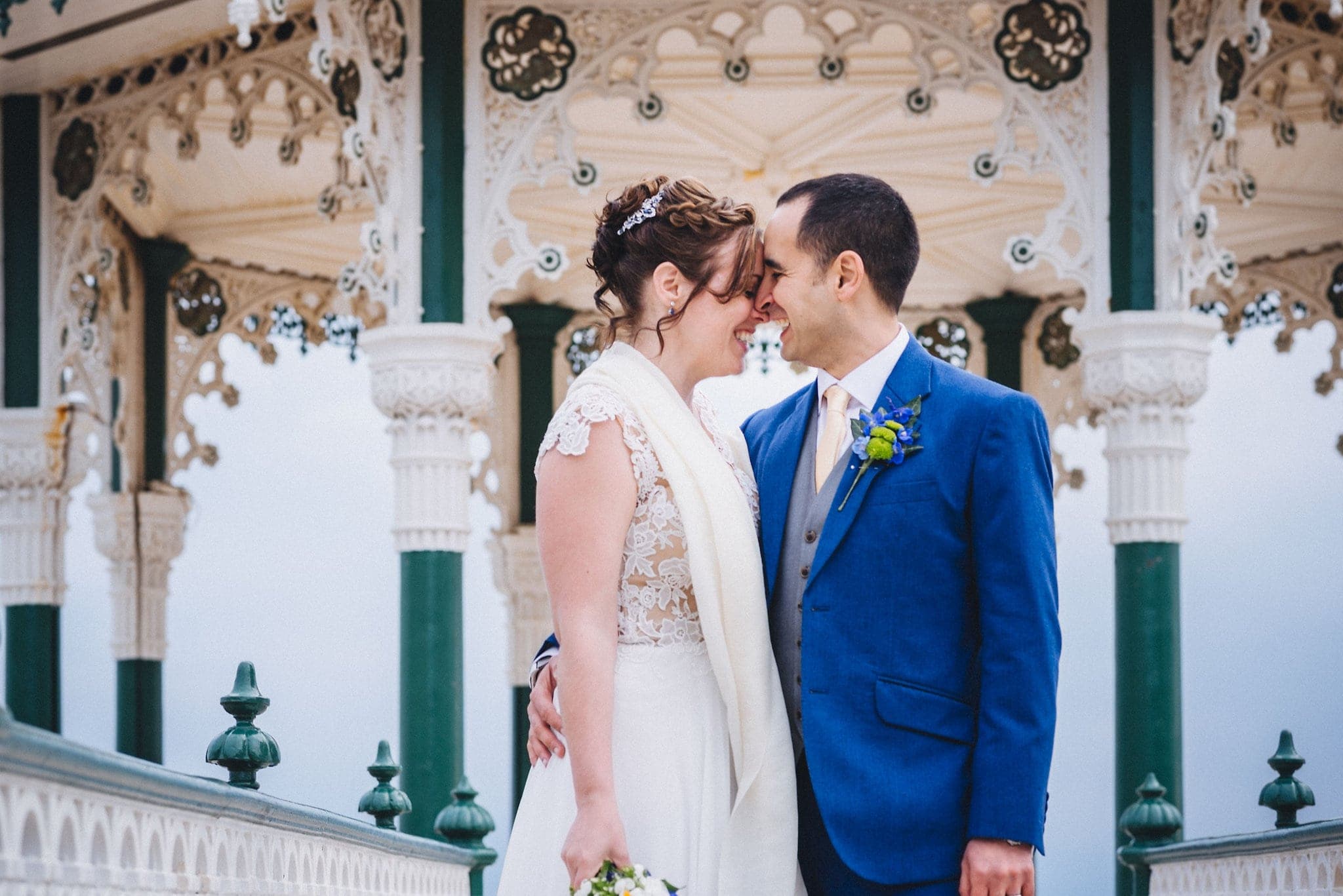 Bride and groom embrace on Brighton bandstand