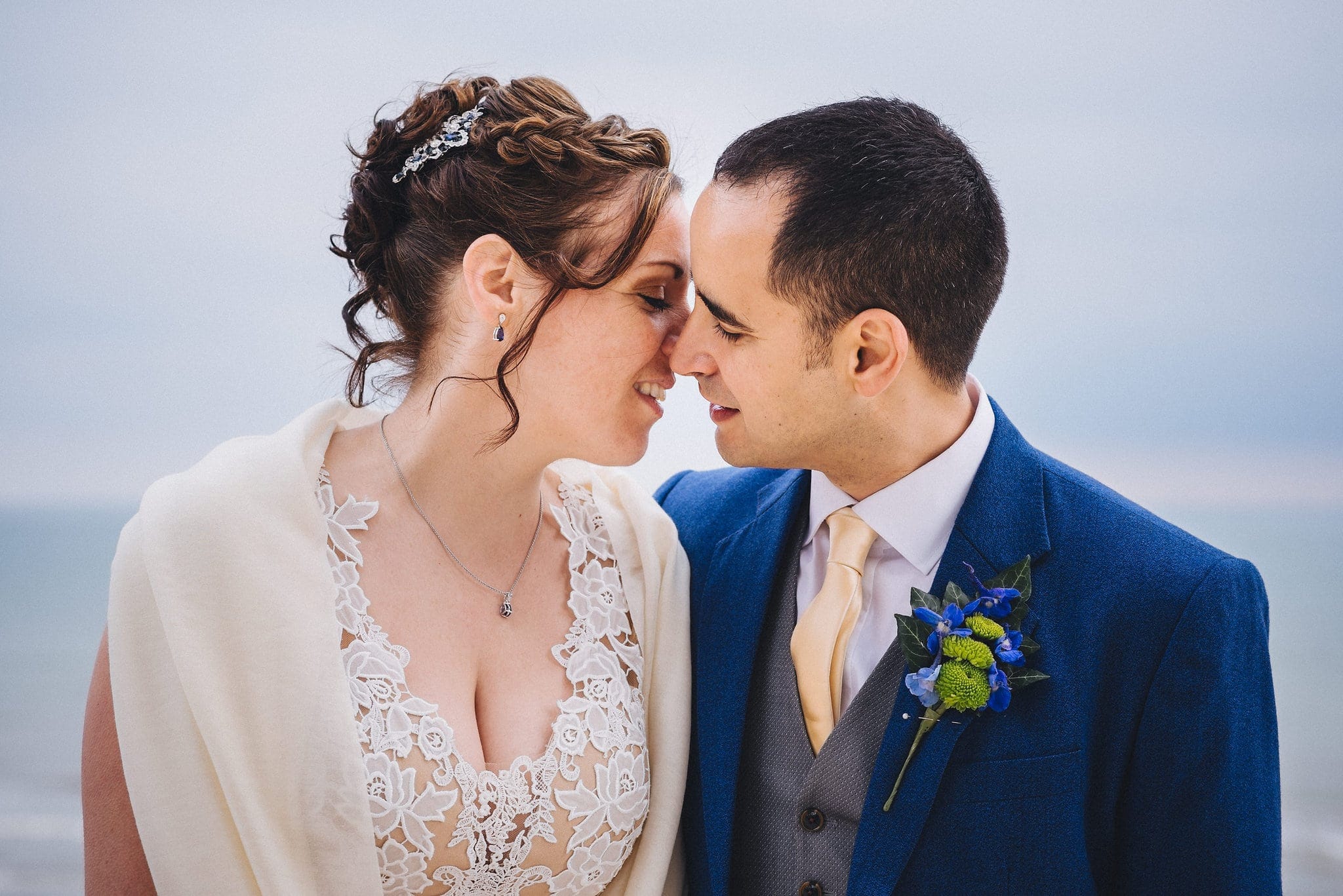 Bride kisses groom on Brighton beach