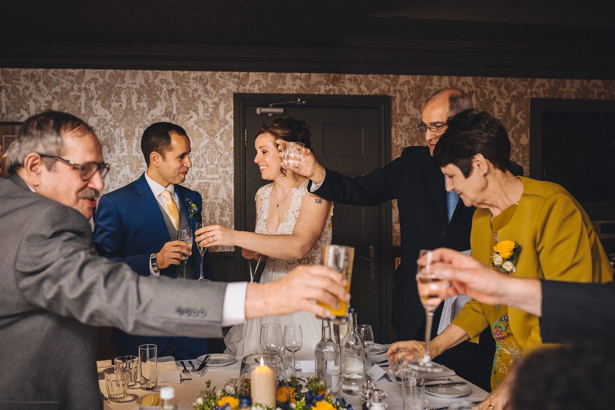 Guests toast bride and groom at wedding reception in Brighton