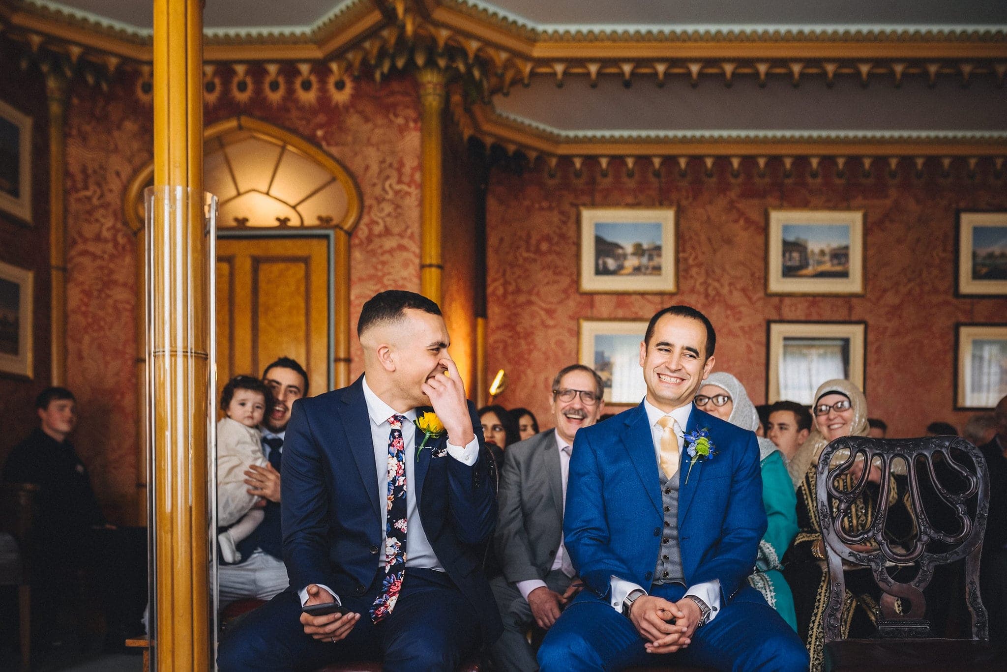 Groom laughs with best man at Brighton Royal Pavilion wedding