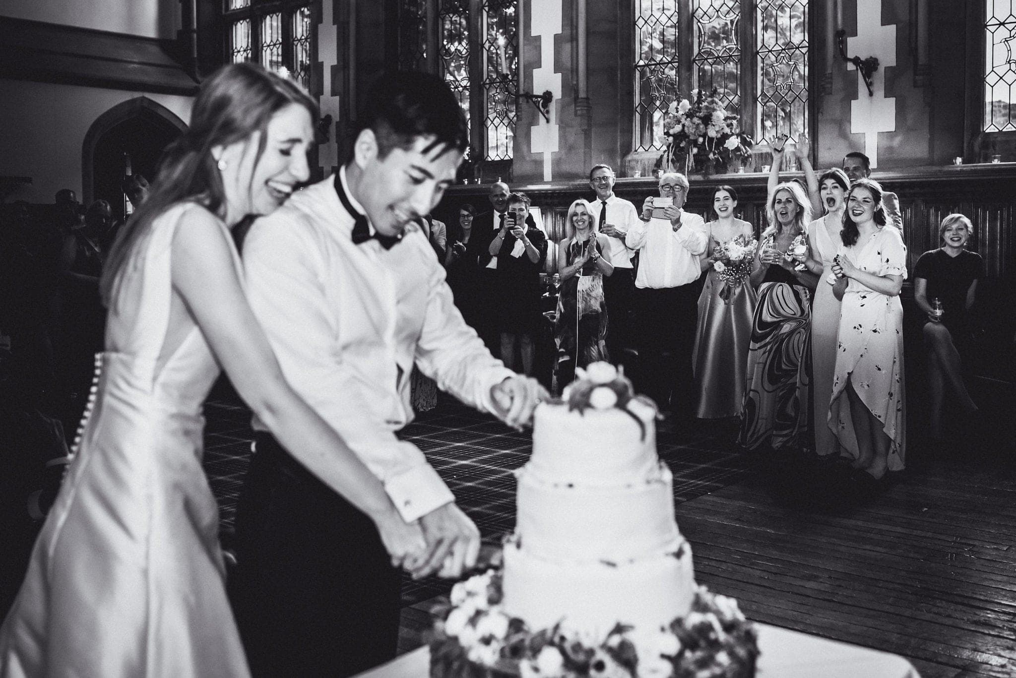 Black and white shot of cake cutting