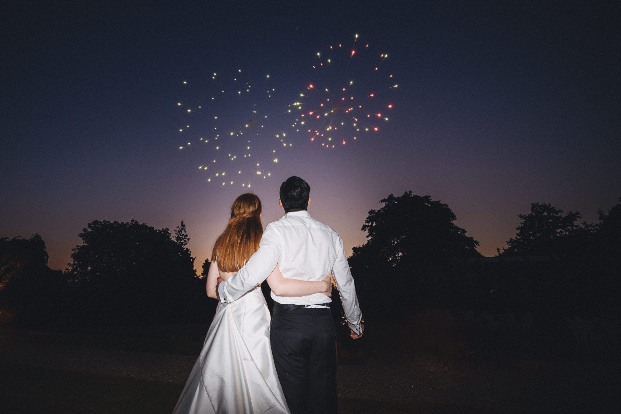 Bride and groom watch fireworks at St Audries Park