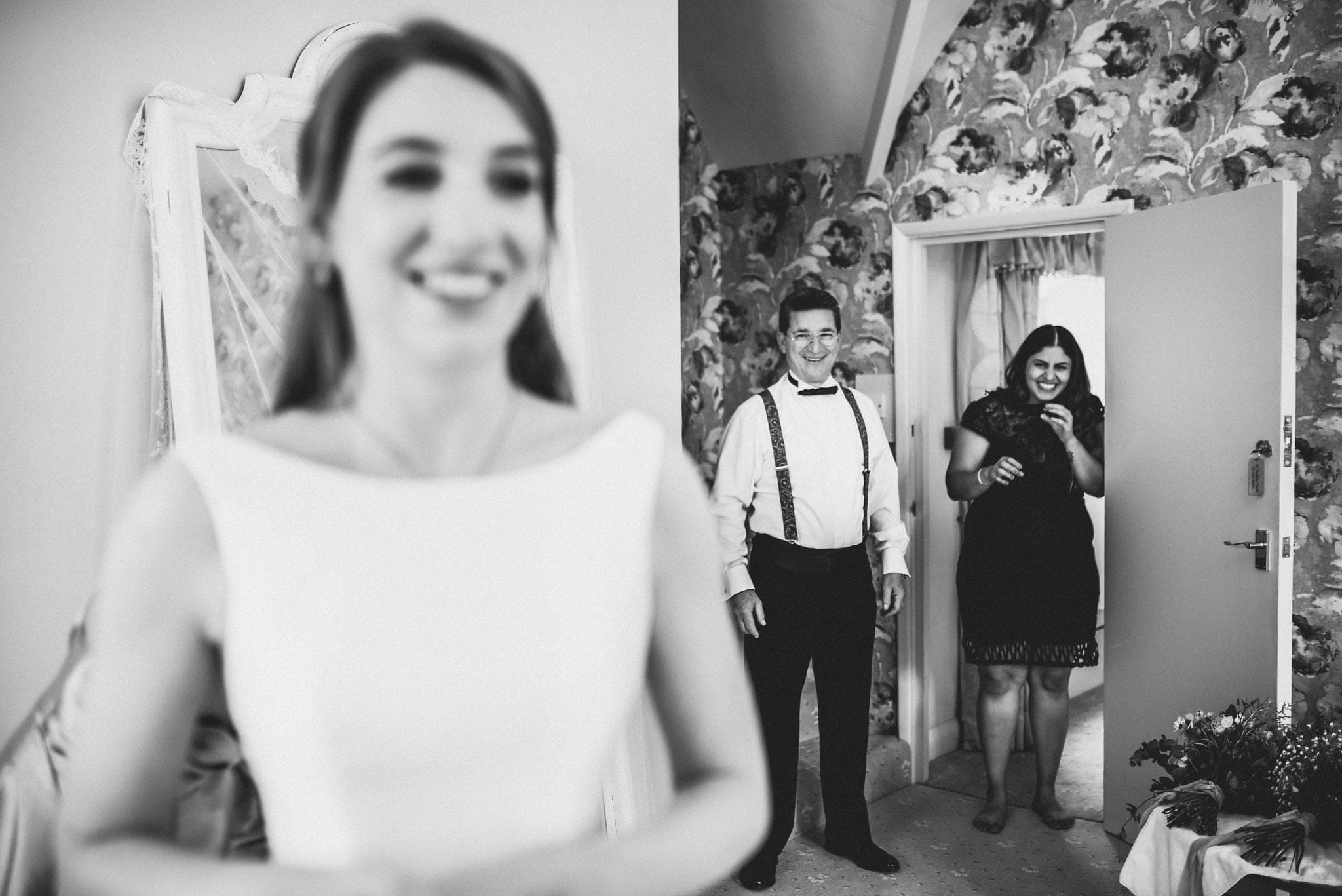 Black and white shot of father of the bride seeing his daughter in her dress for the first time