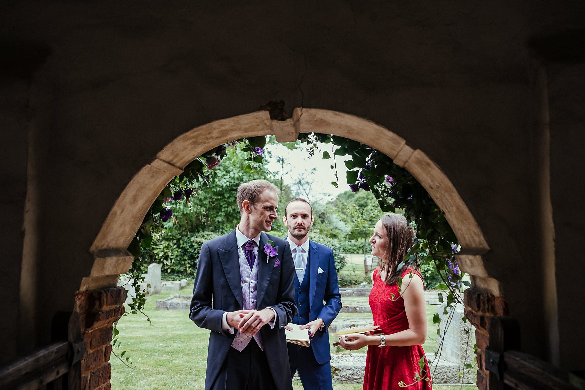 Groom chatting in the church doorway at Dorney Court