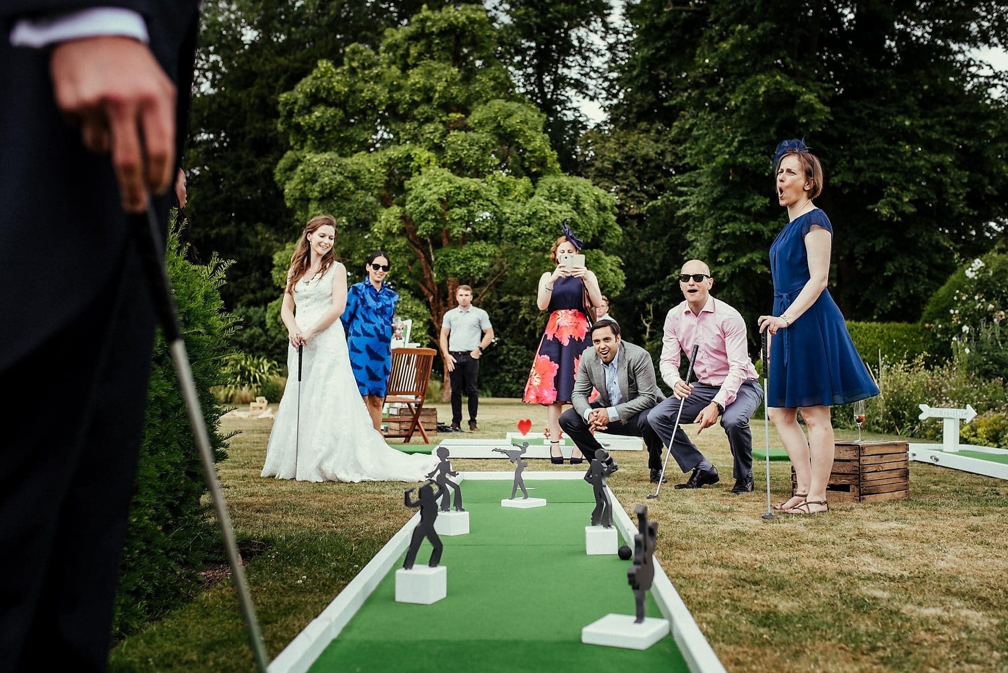 Bride, groom and Wedding guests play mini gold at a Dorney Court Wedding