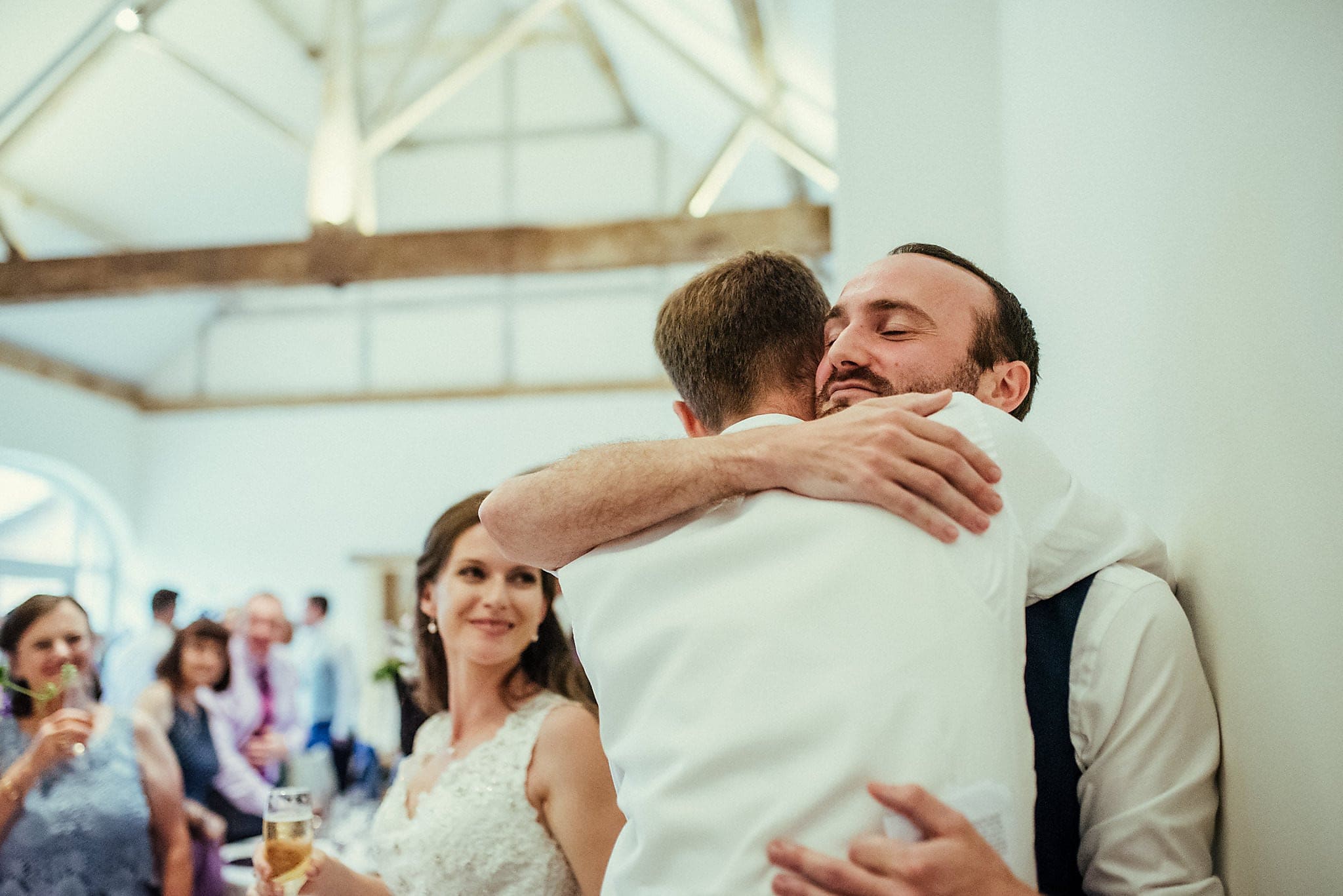 Groom hugging his best man at Dorney Court Barn