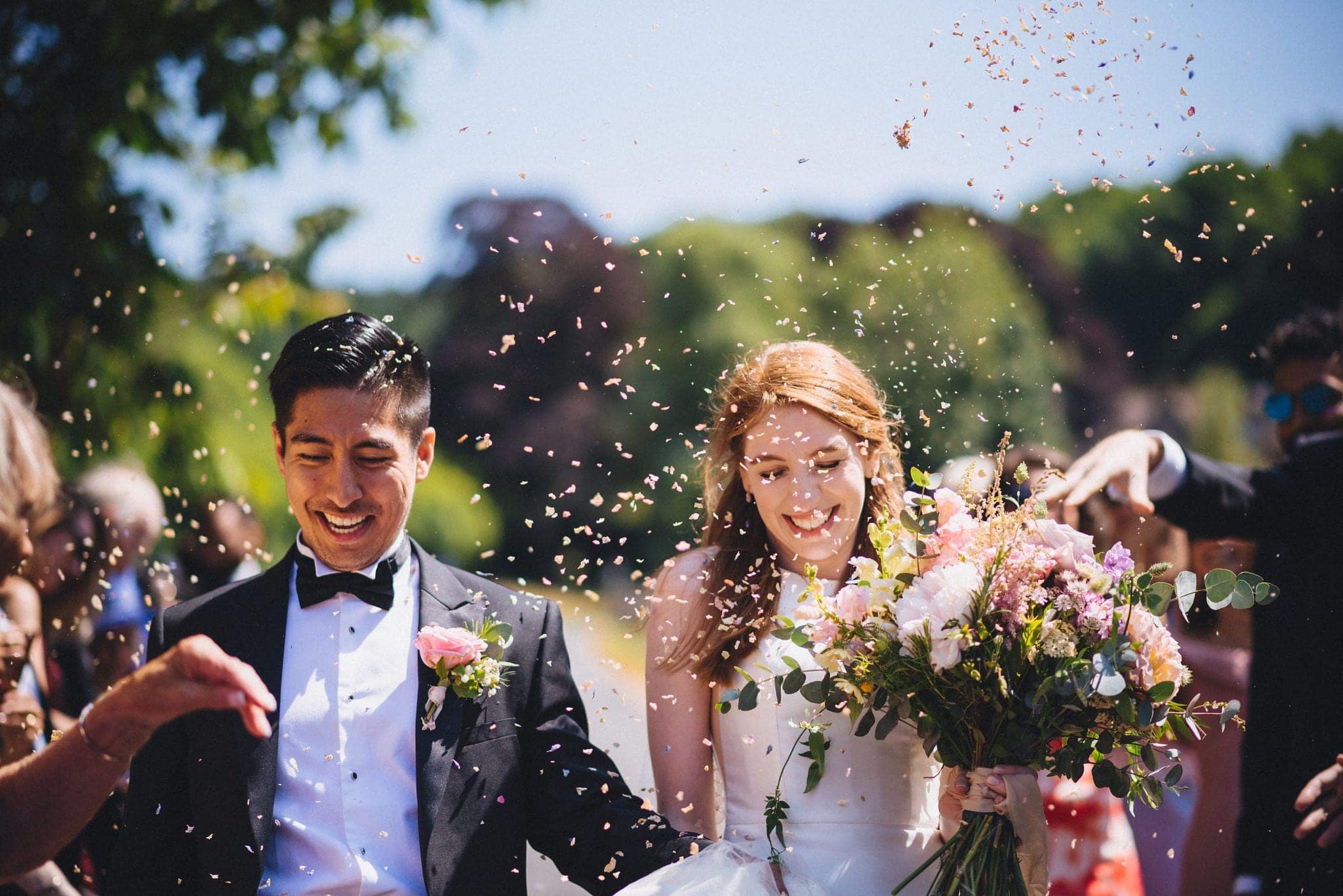 Bride and Groom walking through their confetti shower