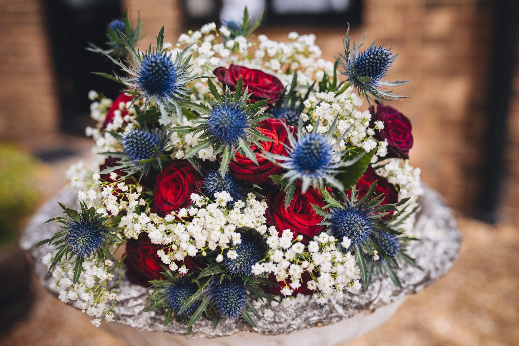 Bouquet with sea thistle, roses and gypsophila