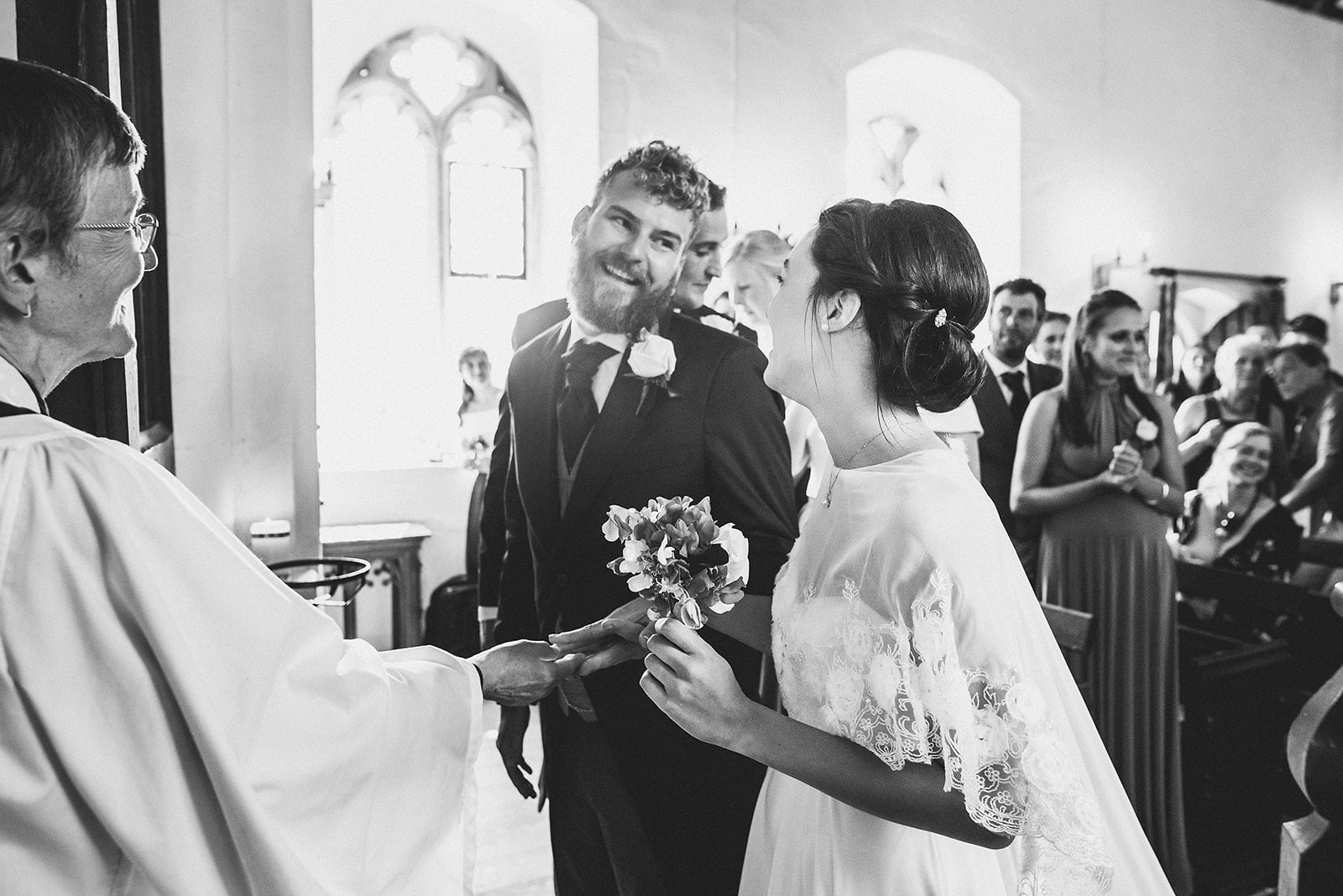 Bride and Groom smile at each other at the top of the aisle