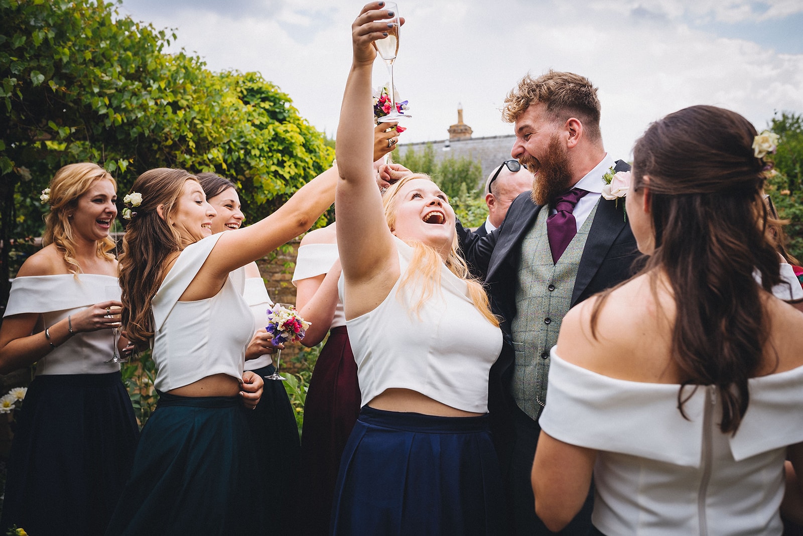 Bridesmaids cheer the groom at a destination wedding