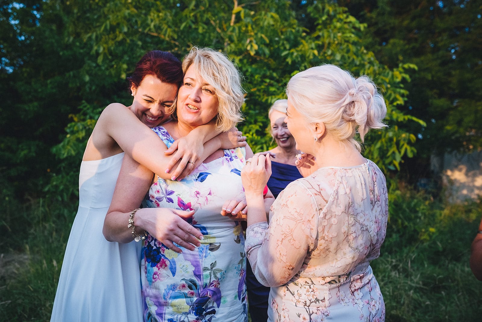 Bride tightly hugging a wedding guest