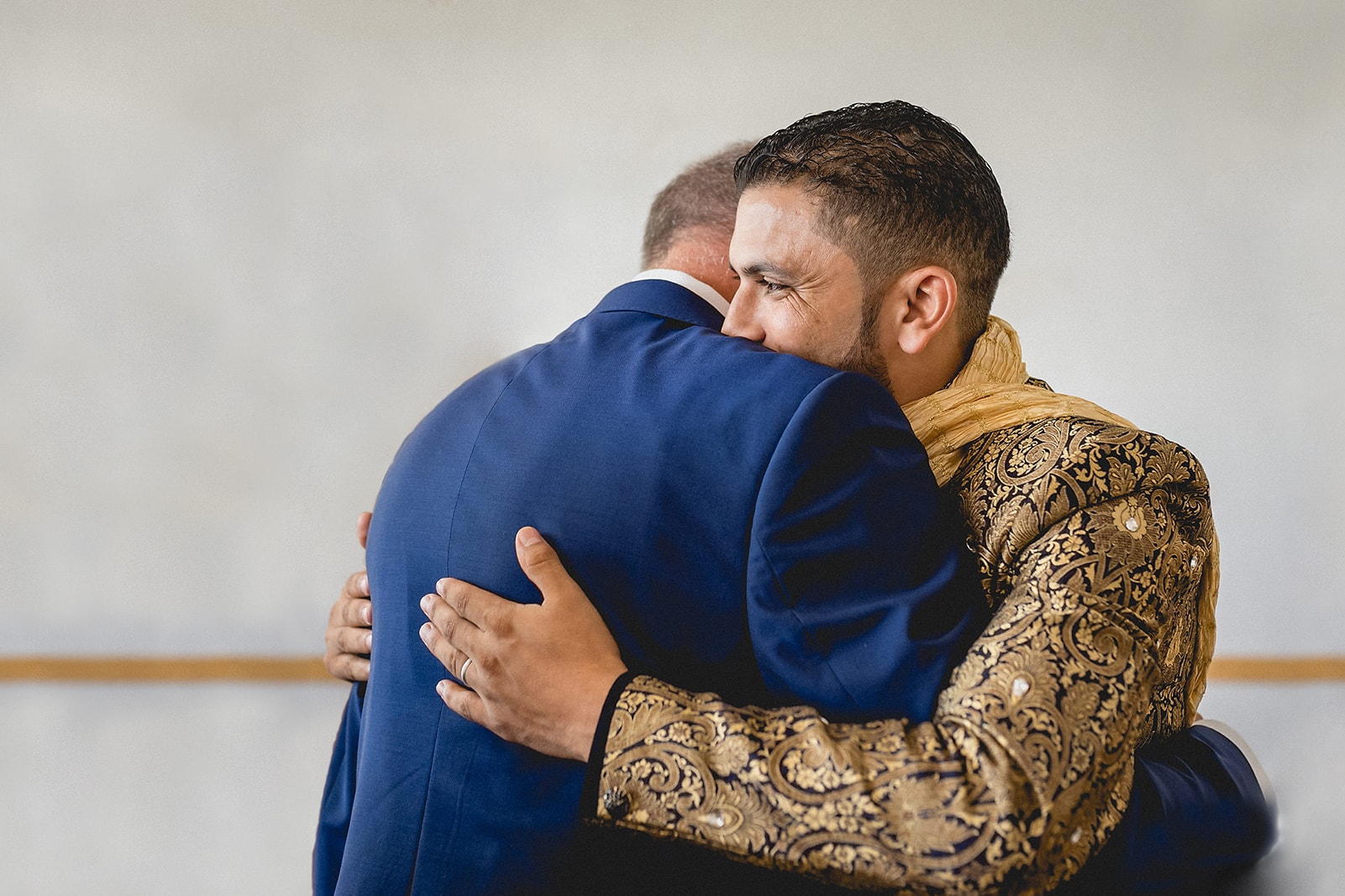 Moroccan Berber groom hugging his father at the end of his Traditional Moroccan Destination Wedding