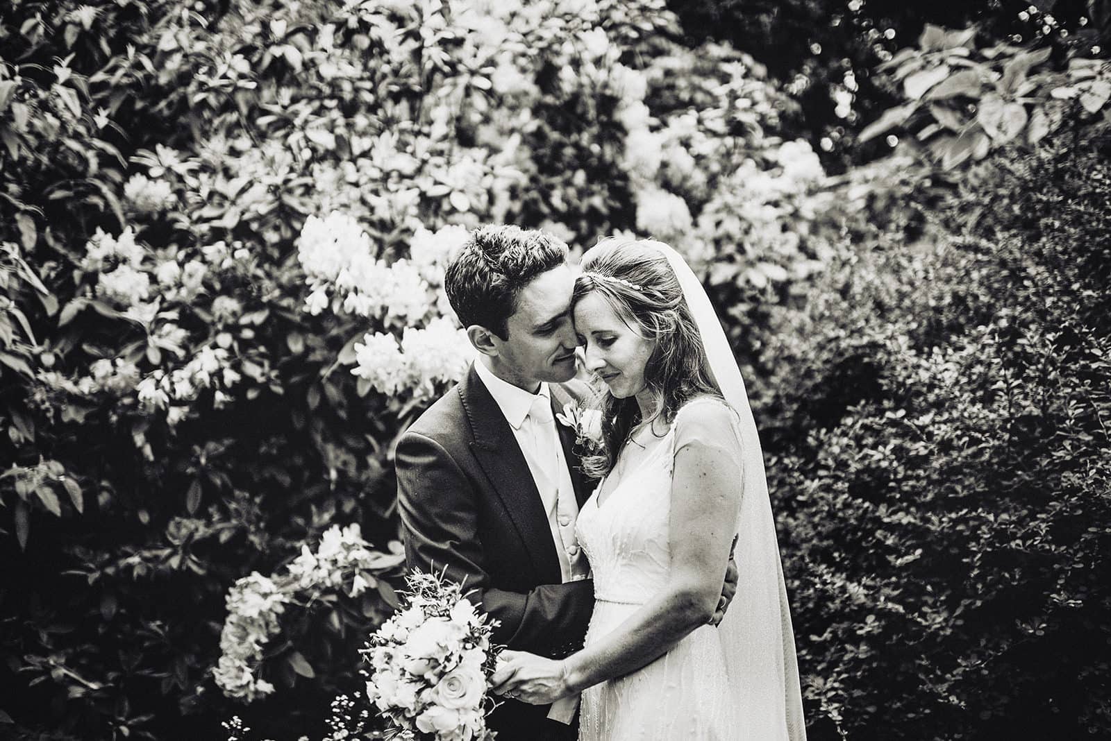 Bride and Groom hug in the Hurlingham Club's sunken garden