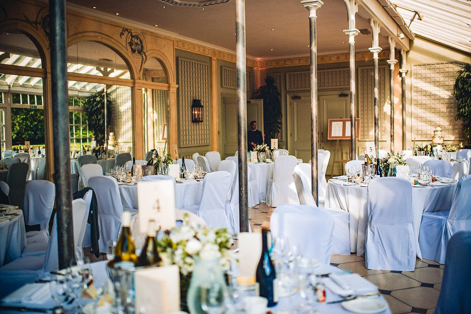 The Terrace Room at the Hurlingham Club set up for an elegant white wedding breakfast