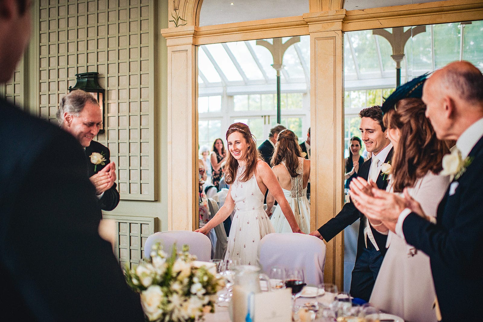 Bride and groom enter the Terrace Room for their Hurlingham Club wedding reception