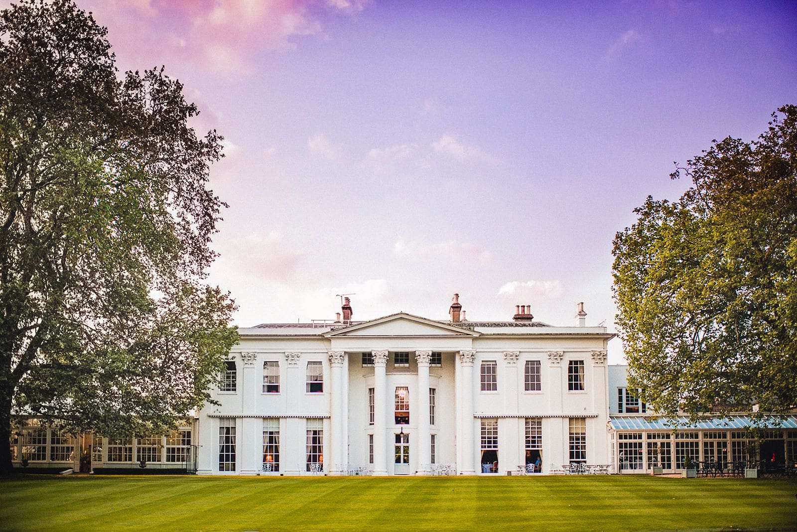 The Hurlingham Club and lawns with a pink sunset sky