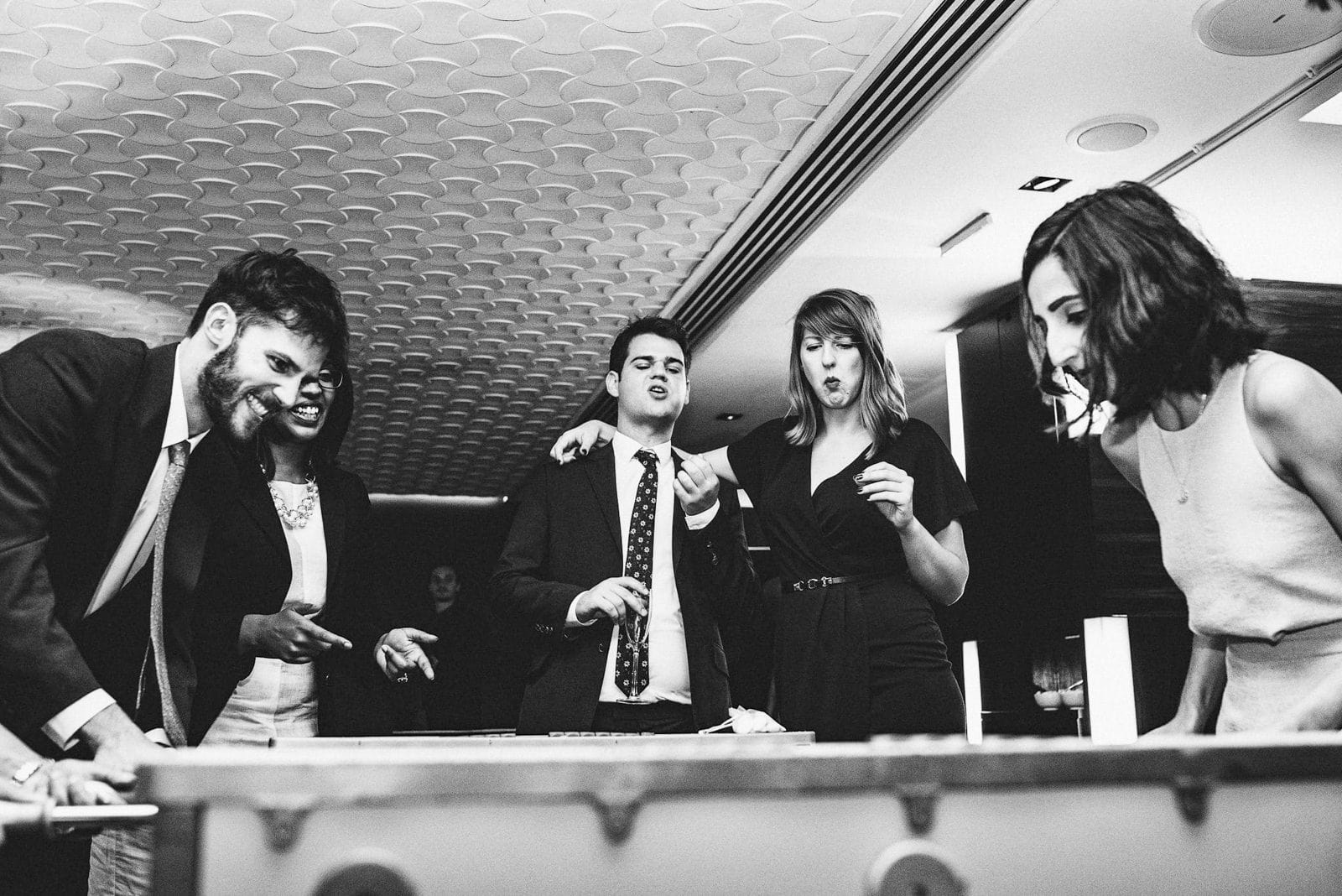 Wedding guests play table football at the Hospital Club in London