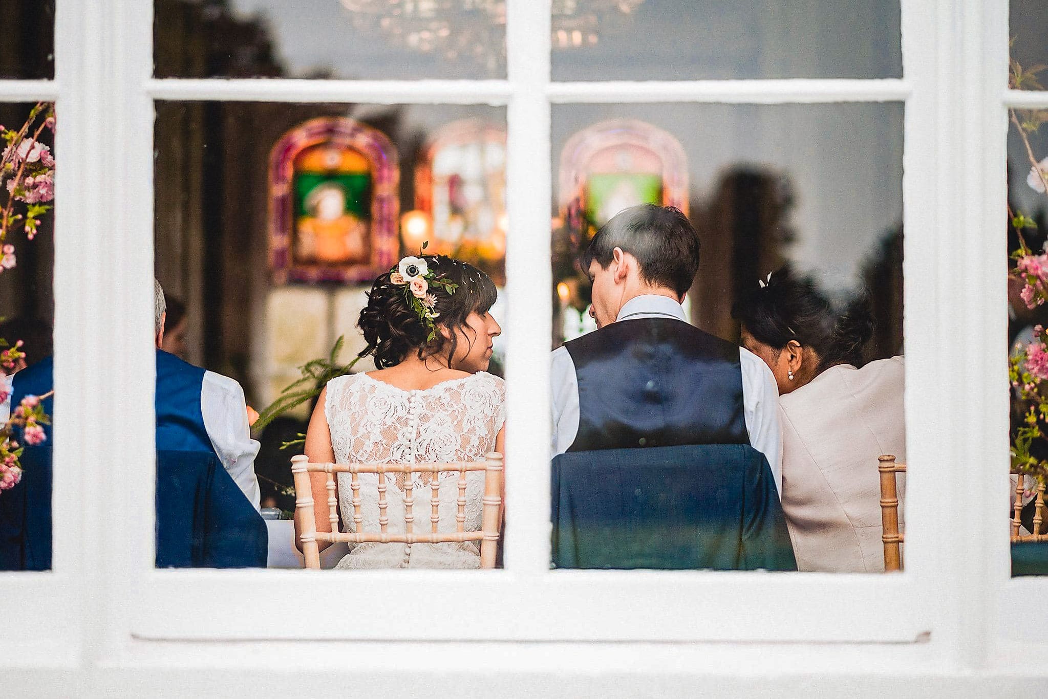 Bride and Groom seen sitting through a glass window