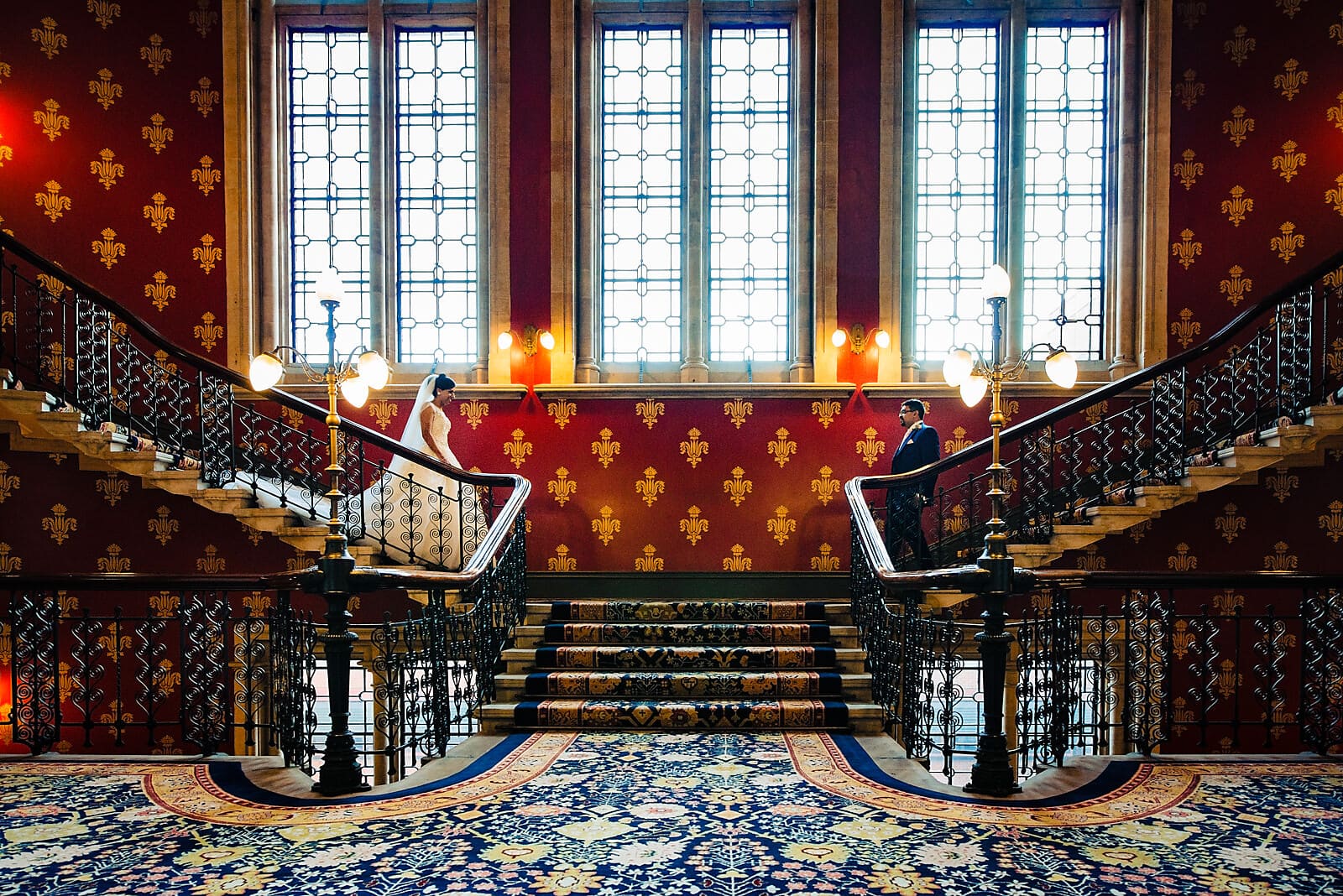 Bride and groom walk down the stairs at their St Pancras Renaissance Hotel Wedding