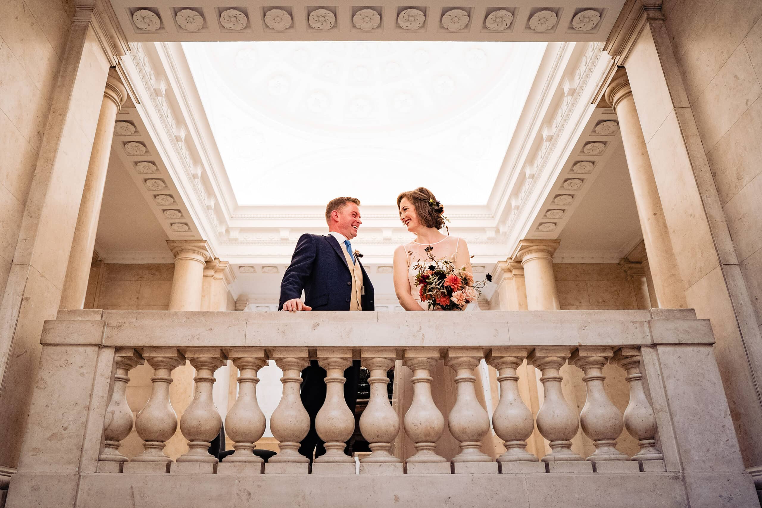 Bride and groom smile at each other at their Old Marylebone Town Hall Wedding ceremony