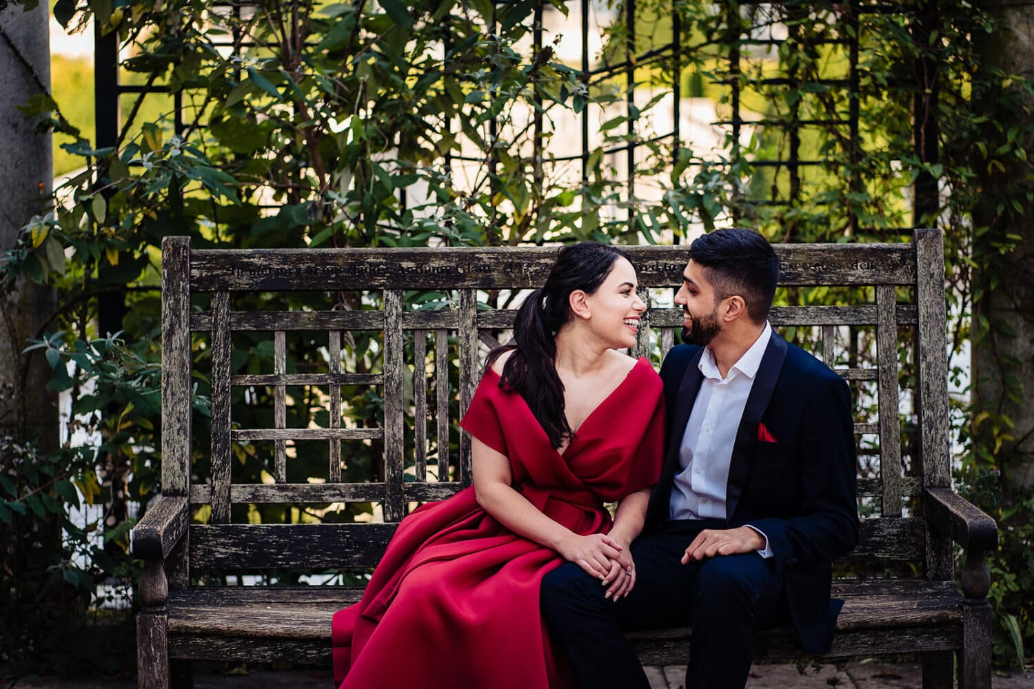 Couple laugh sitting on bench at the Hampstead Pergola and Gardens