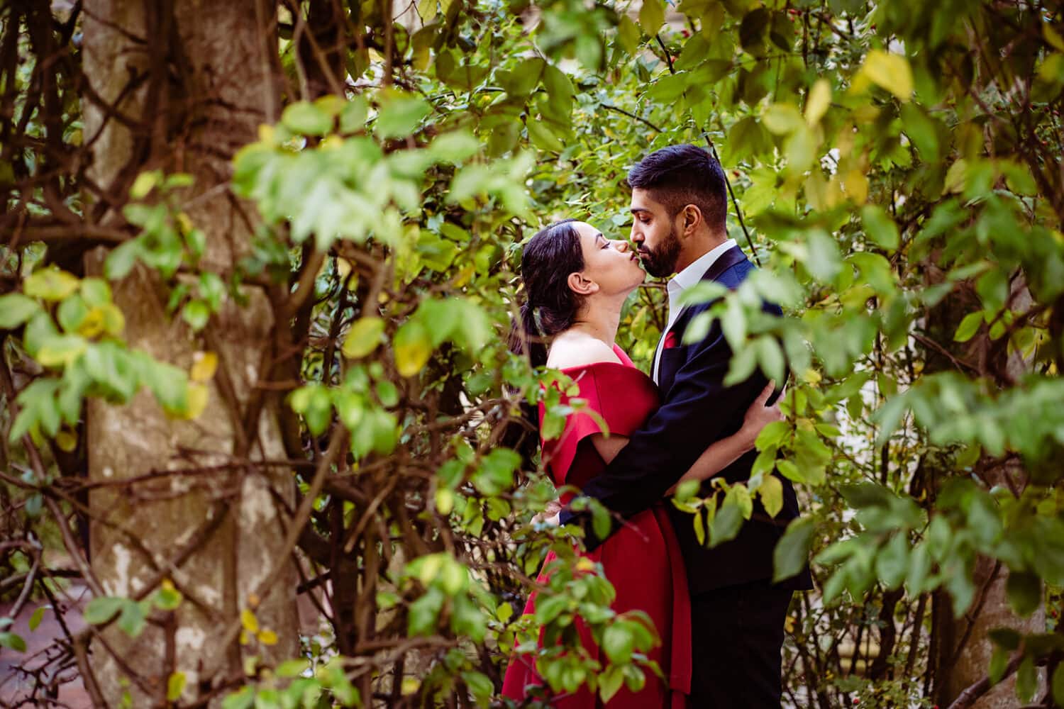 Asian couple kiss at their Hampstead Pergola engagement shoot