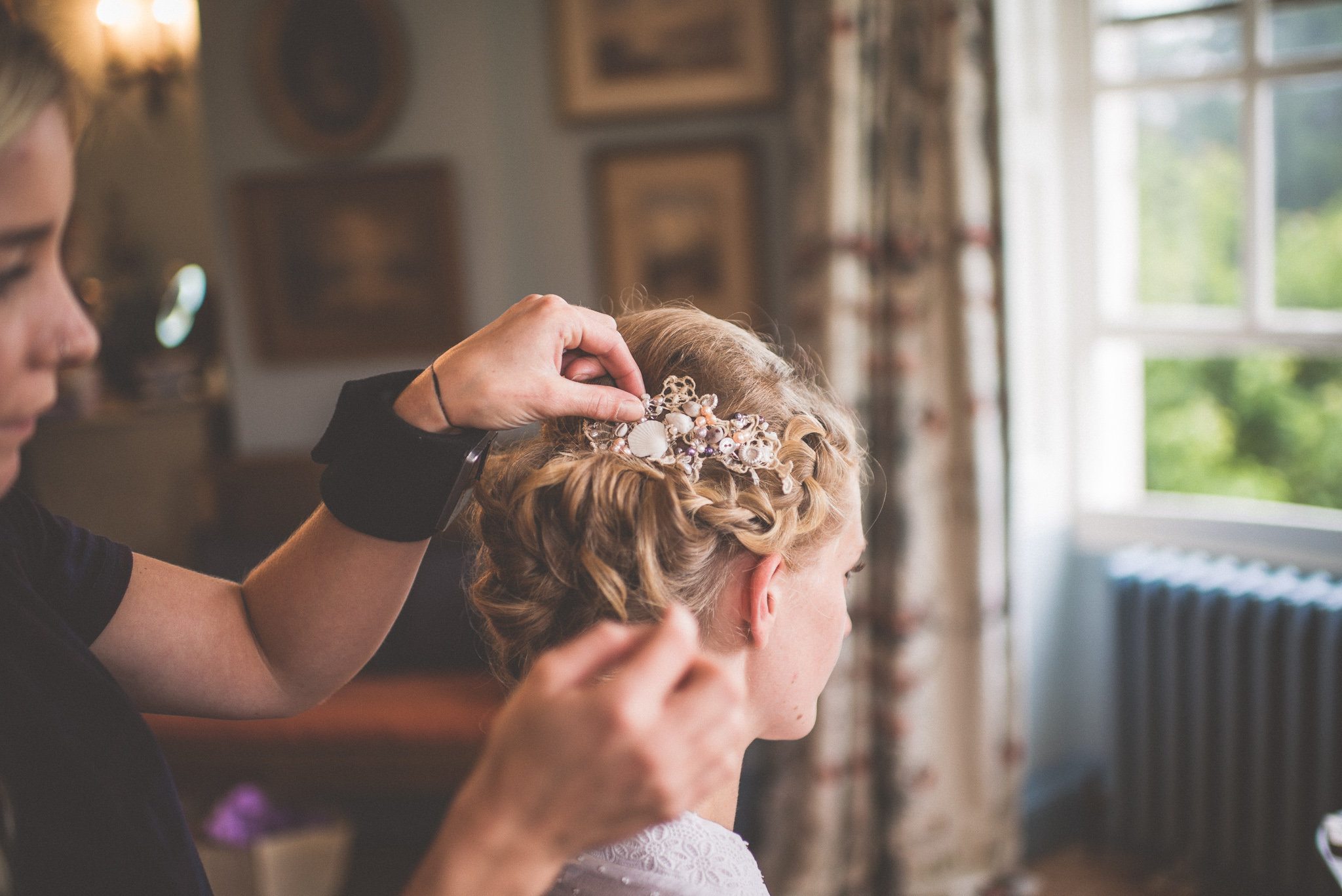Bride has her hair done before her wedding at Smedmore House