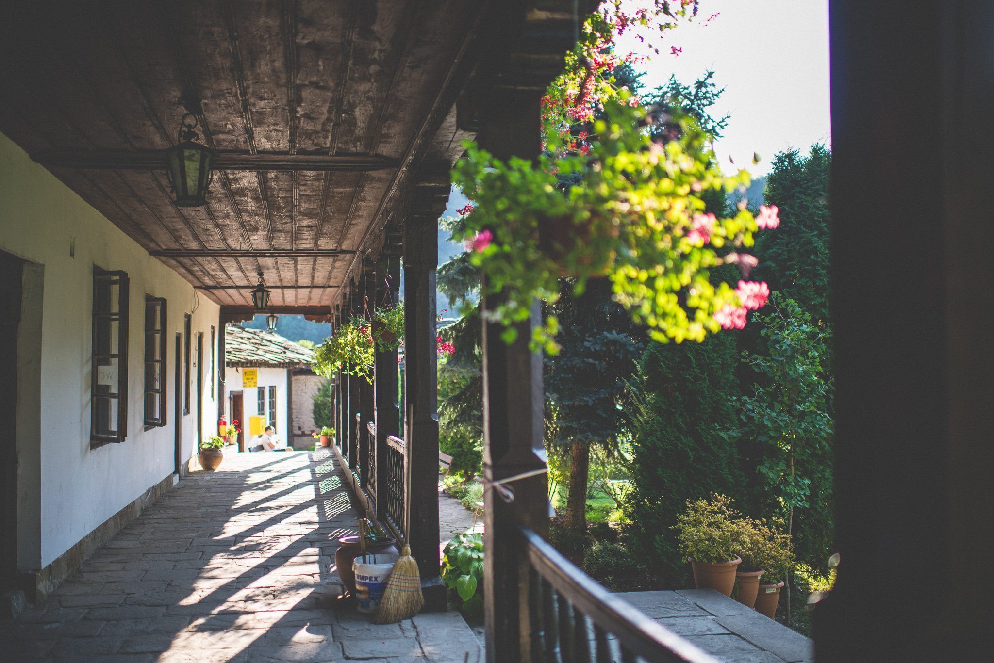 Baskets of flowers hang along the wooden verandah of the Troyan monastery