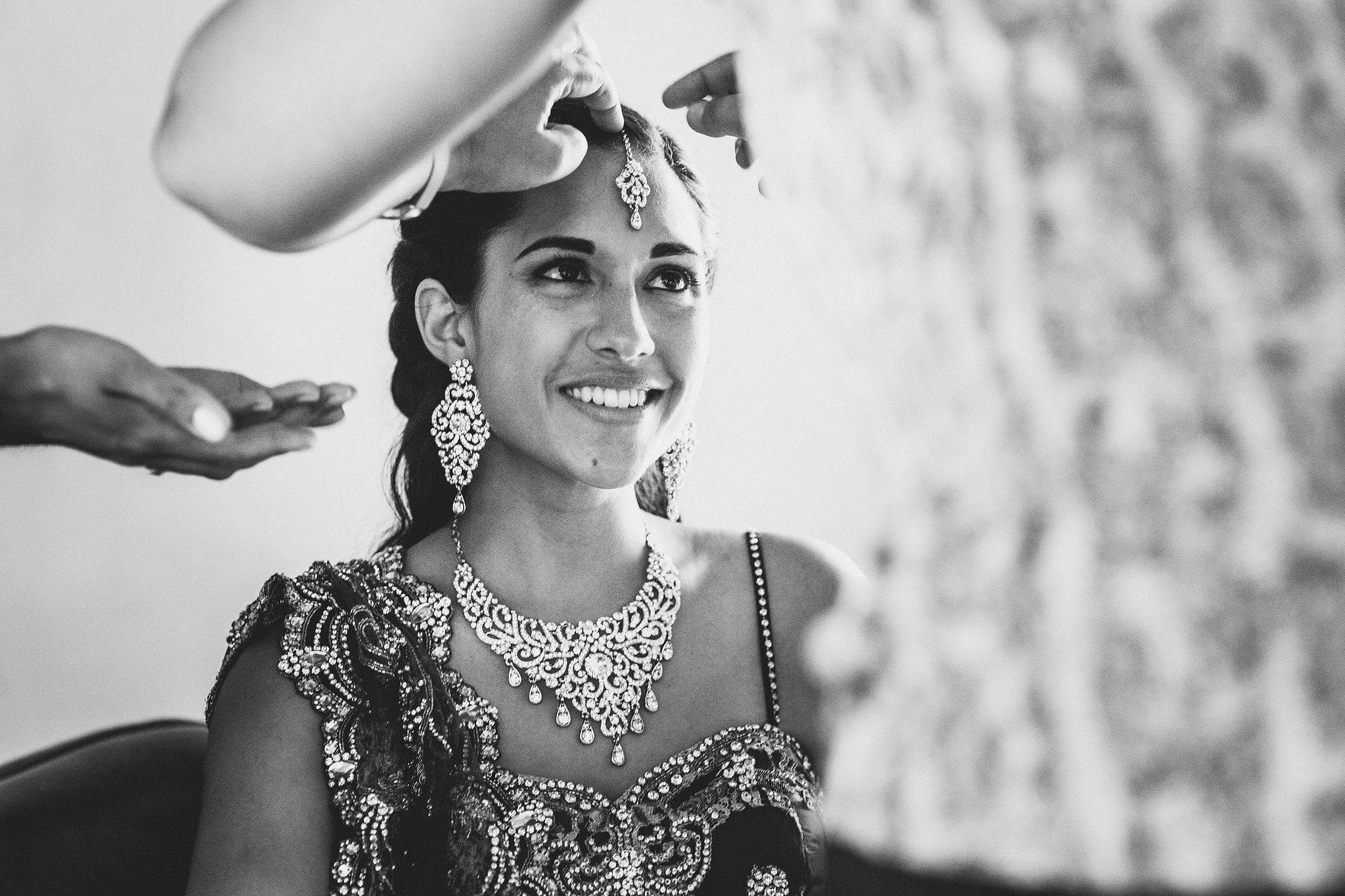 Indian bride's jewellery being put on for her Majorelle Gardens Marrakech destination wedding