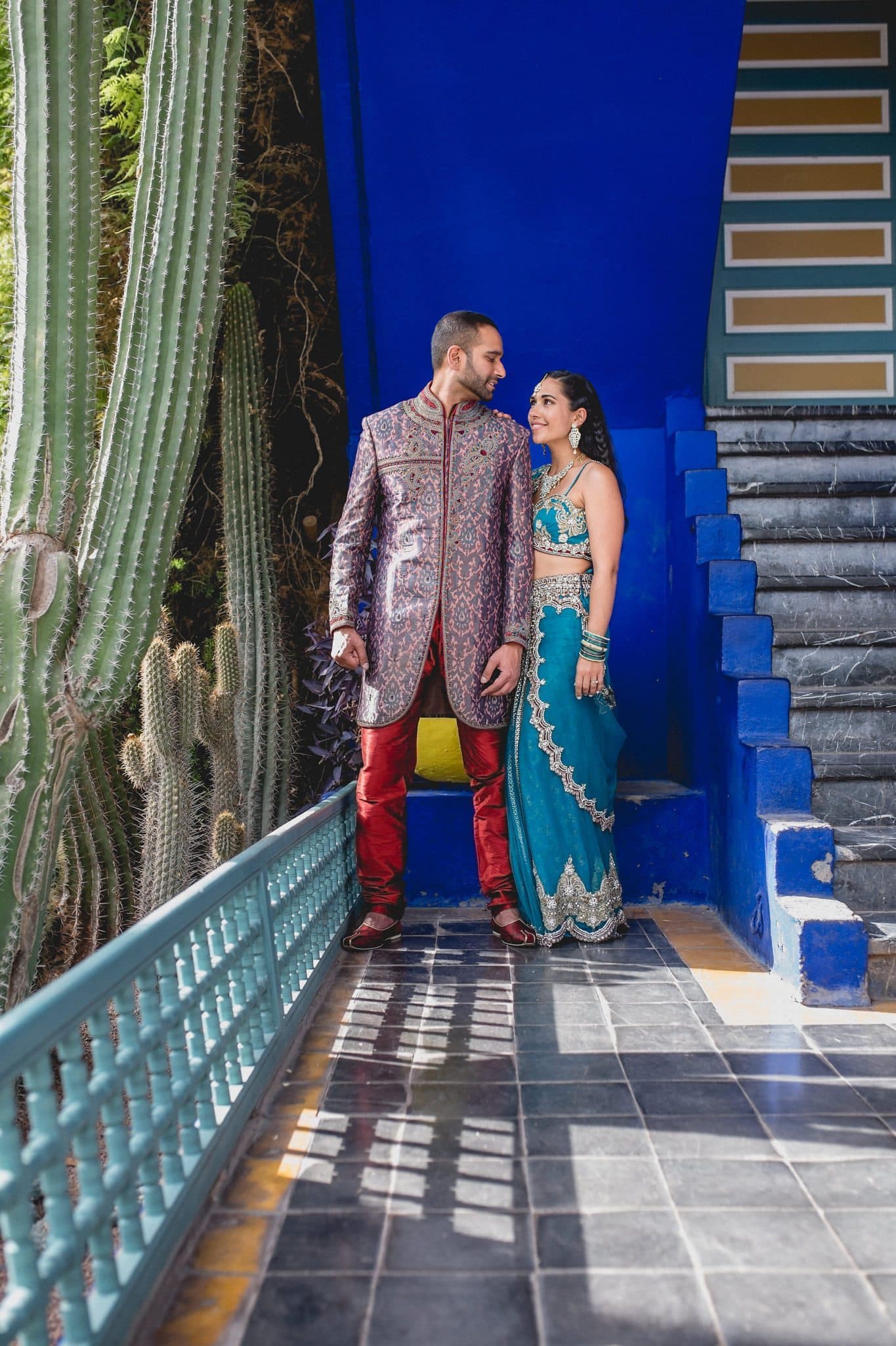 Asian Bride and Groom look at each at the Majorelle Gardens in Marrakech