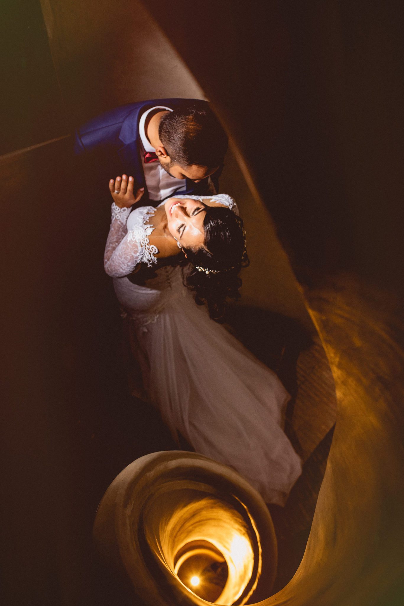 Glamorous bride and groom at the spiral staircase at Ksar Char Bagh