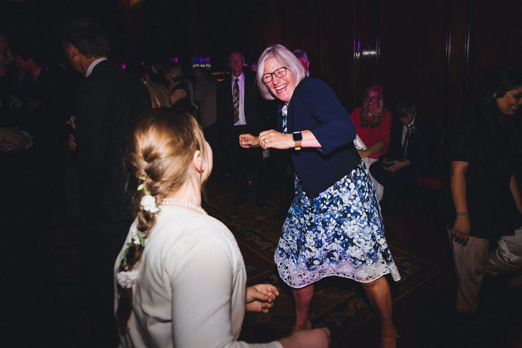 Woman dances with child at wedding reception