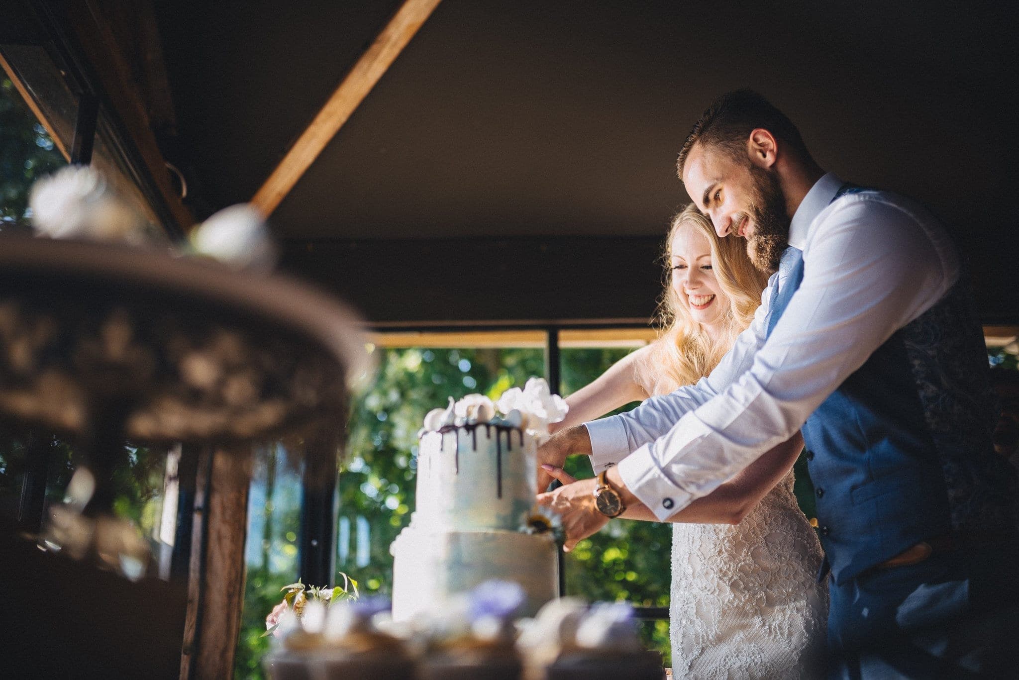 Bride and Groom cutting their wedding cake at their Dewsall Court Wedding